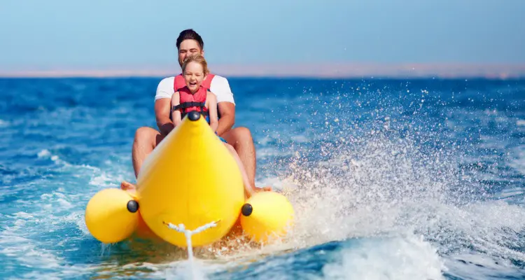 father and son on a banana boat