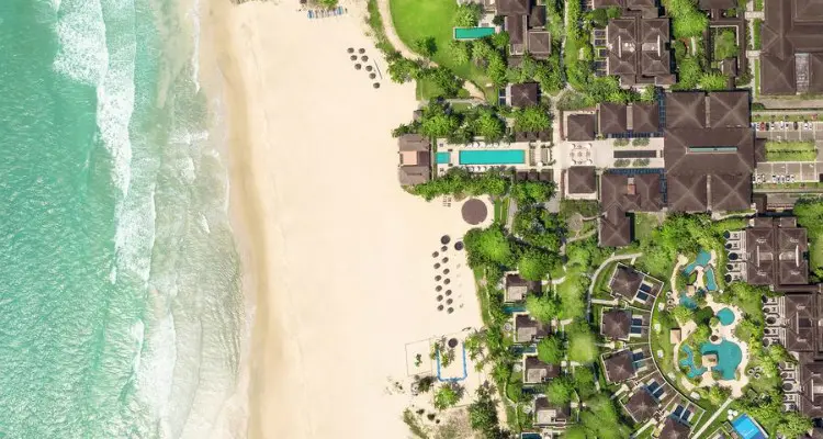 hotel on the beach with a swimming pool