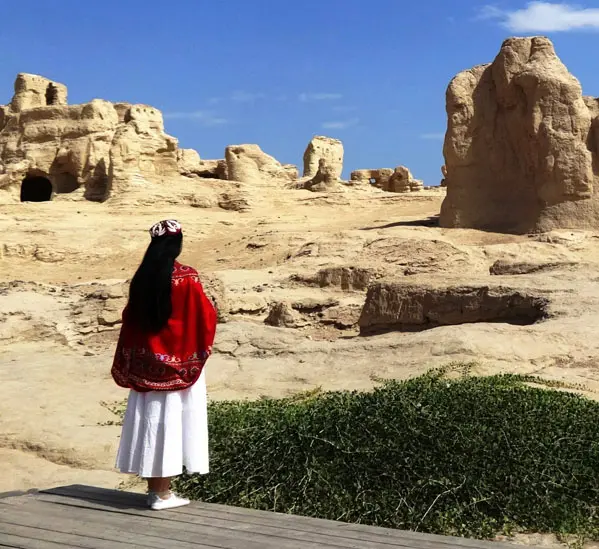 A girl with red dress at the Jiaohe Ancient City
