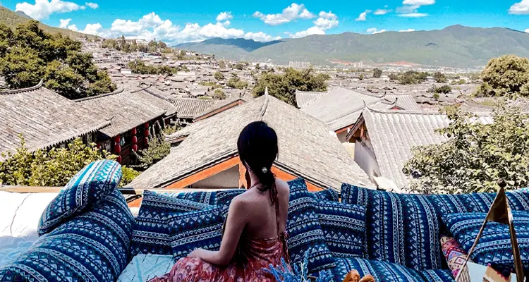 Climb to the roof of a well-placed restaurant and overlook Lijiang Old Town